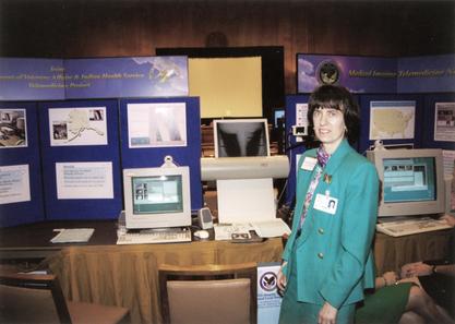 Ruth Dayhoff at Congressional demonstration of VistA Imaging.  On exhibit is a VistA Imaging workstation with xray film scanner used in a joint project between the VA and the Indian Health Service to provide orthopedic coverage to Alaska, 1996