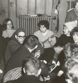 Catherine DeAngelis playing guitar, with fellow students at Wilkes College, 1960s