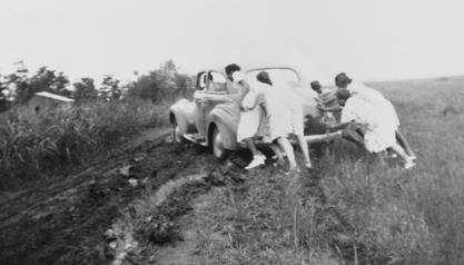 The Mississippi Health Project team pushing their car out of the mud, 1940