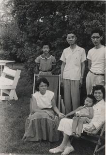 Rebekah Wang-Cheng sitting on her mother's lap along with other family members Ruthie, Ester, John, and her father, ca.1956