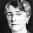 Full face photograph of Dr. Louise Pearce wearing glasses.